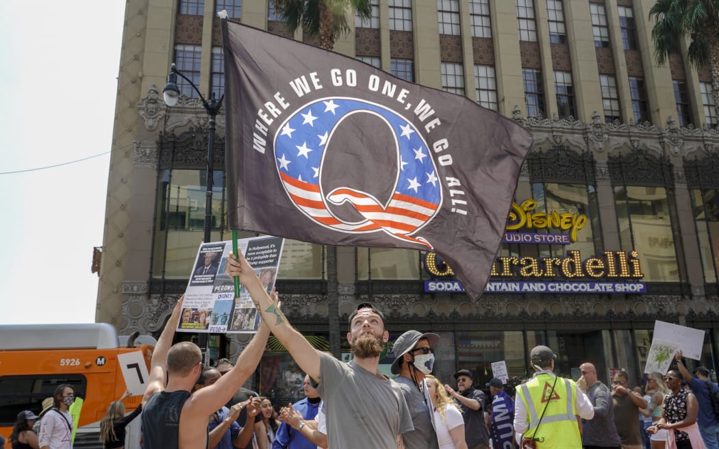 In this file photo conspiracy theorist QAnon demonstrators protest child trafficking on Hollywood Boulevard in Los Angeles, California, August 22, 2020.