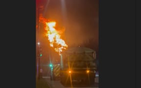This frame grab taken from a UGC video shot and posted on X on March 21, 2025 by @fire_at_Vill shows a fire burning at a neighborhood electrical substation supplying power to Heathrow Airport in Hayes, west London.