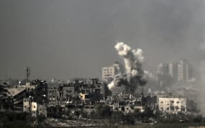 A picture taken from near the southern Israeli city of Sderot on October 28, 2023, shows smoke raising during an Israeli strike in the northern Gaza Strip. Israeli air strikes destroyed hundreds of buildings in the Gaza Strip overnight, the civil defence service in the Hamas-controlled Palestinian territory said on October 28. (Photo by Aris MESSINIS / AFP)