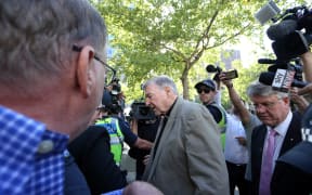 Cardinal George Pell makes his way through media as he arrives at court in Melbourne on 27 February 2019 for a sentence plea hearing.