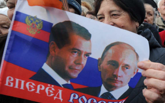 Protesters at a pro-Russian rally waved flags depicting the Russian president and Russian prime minister.