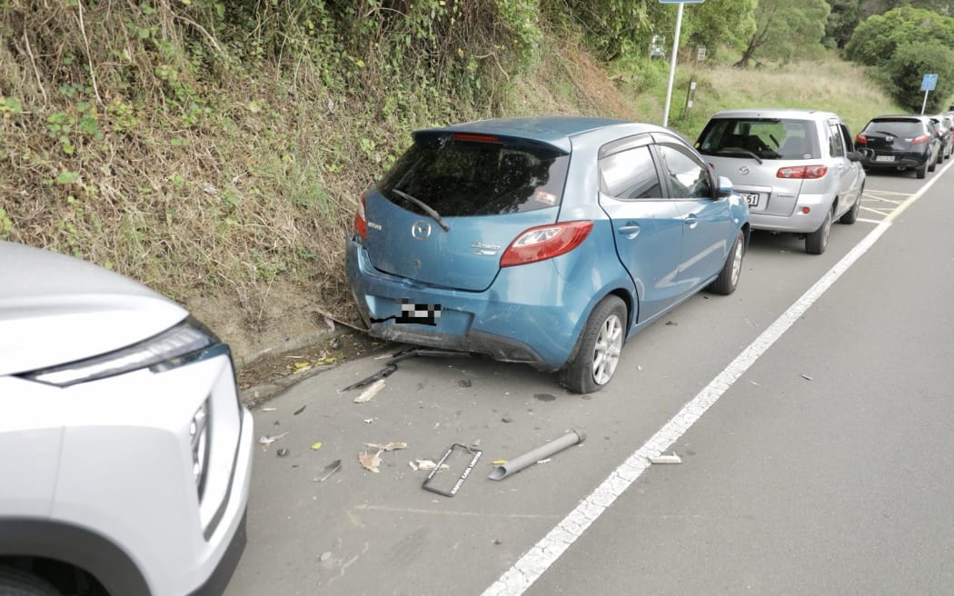 Multiple parked vehicles were damaged by a driver in a stolen vehicle towing a caravan that was fleeing police.