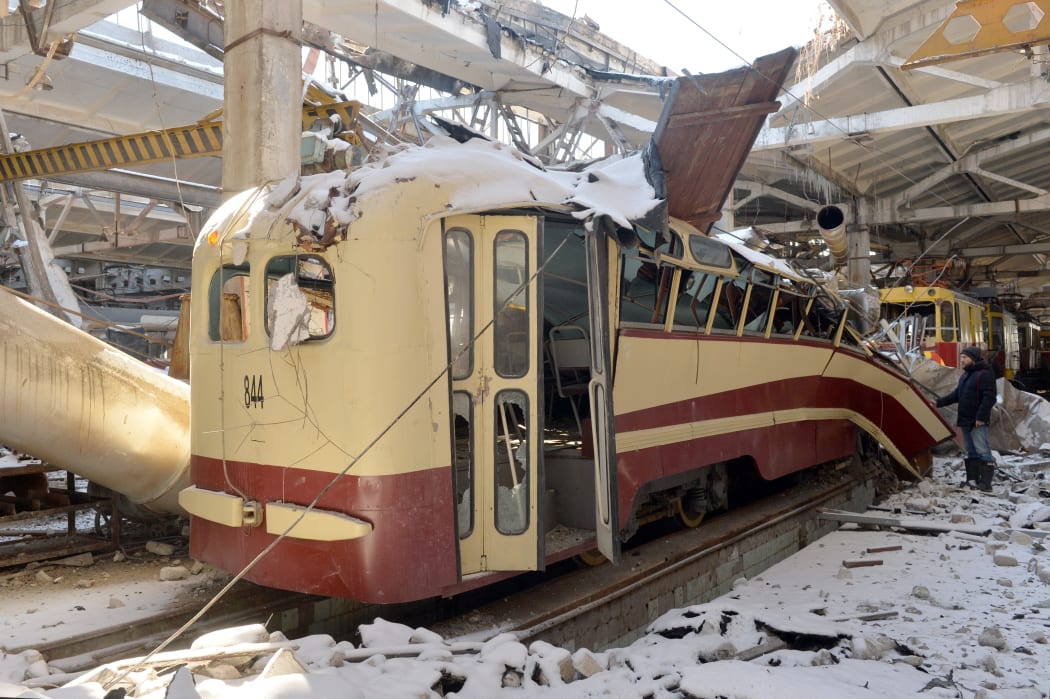 A resident examines a destroyed tram depot in Kharkiv on March 12, 2022.