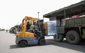 A forklift collects supplies from the 2nd army convoy to arrive in Kaikoura.