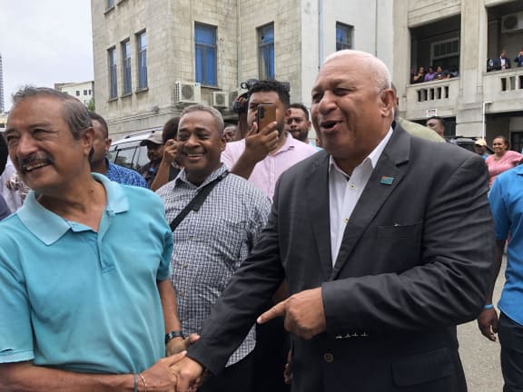 Bainimarama in a more jovial mood after being granted an absolute discharge without a conviction.