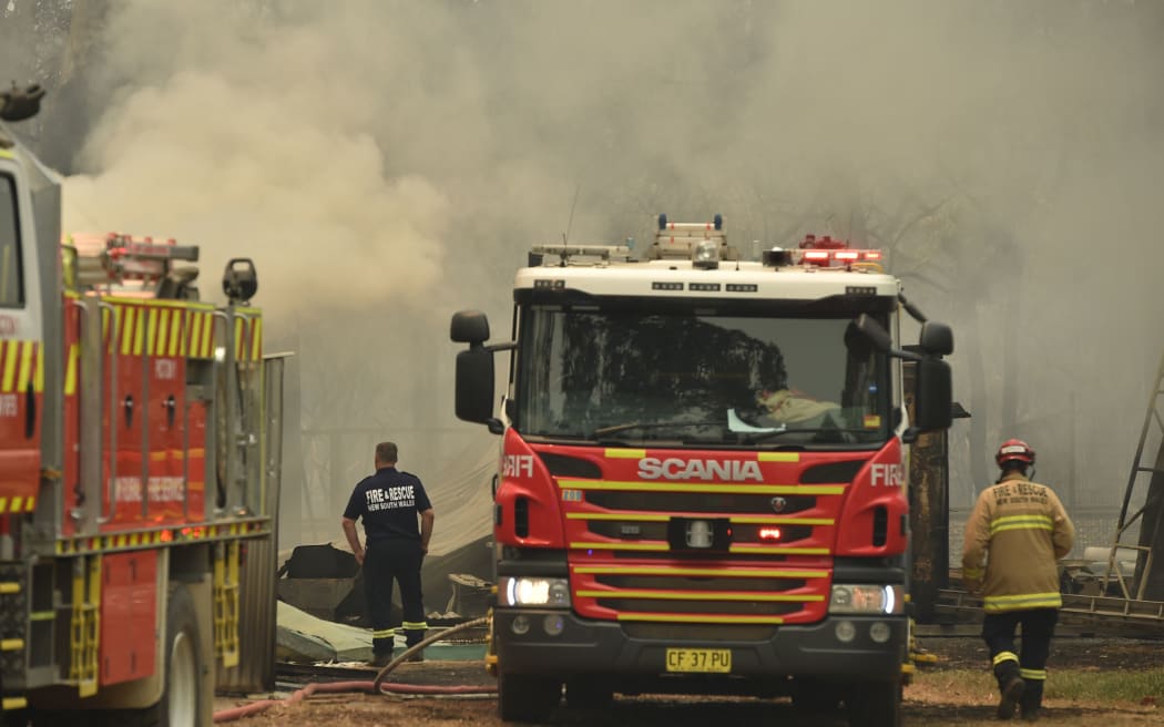 Firefighters tend to burning property caused by bushfires in Bargo, southwest of Sydney, on December 21, 2019. -