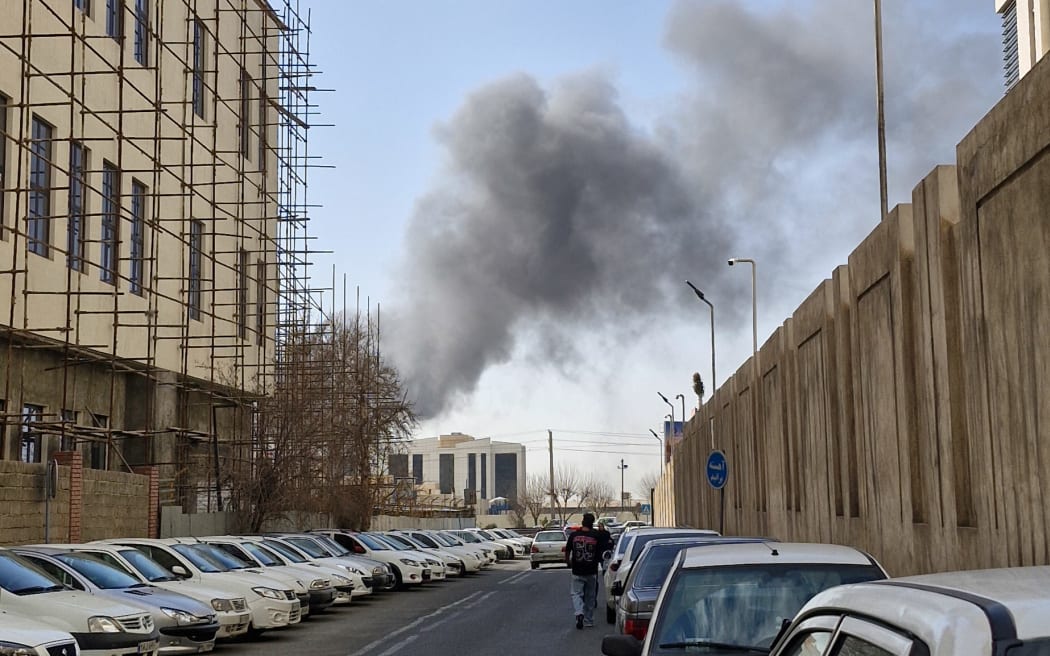 A plume of smoke rises over Tehran after a reported explosion on February 28, 2026, after Israel said it carried out a “preemptive strike” on Iran as sirens sounded in Jerusalem and phone alerts warned of an “extremely serious” threat. (Photo by Ehsan / Middle East Images via AFP)