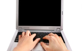 Woman typing on laptop