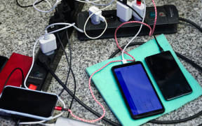 Mobile phones of refugees who arrived from Ukraine are charging at the main railway station in Krakow, Poland on March 8, 2022. Russian invasion on Ukraine can cause a mass exodus of refugees to Poland.   (Photo by Beata Zawrzel/NurPhoto) (Photo by Beata Zawrzel / NurPhoto / NurPhoto via AFP)