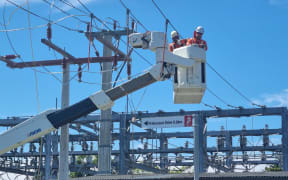 Electrical crews in hi-vis working to repair broken or damaged lines at Taradale Road switching yard.