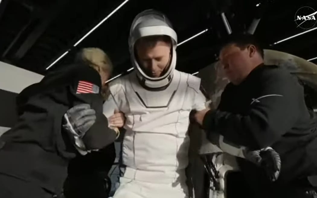 Crew-9 Commander Nick Hague is wheeled out of the SpaceX pod and onto the recovery vessel