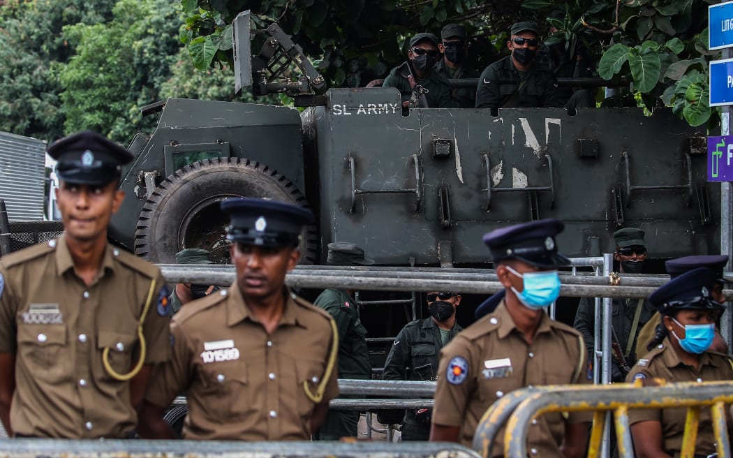 Sri Lankan Army and police personnel stands guard outside the Parliament building in Colombo on July 20, 2022.