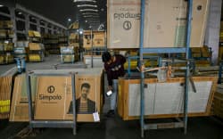A worker scans tiles at a ceramics factory facing propane shortages, in the Indian city of Morbi: Blazing-hot kilns employing hundreds of thousands of people have gone cold, shut down in an energy crunch sparked by the US-Israeli strikes on Iran.