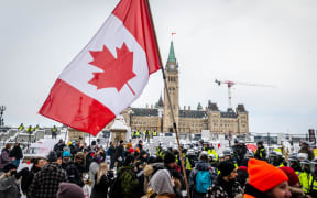 Demonstrators continue their protest in front of Parliament Hill in Ottawa as police deploy to remove them.