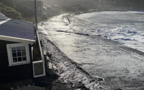 Swells come up onto the road and threaten Ōwhiro Bay homes in Apirl 2020.