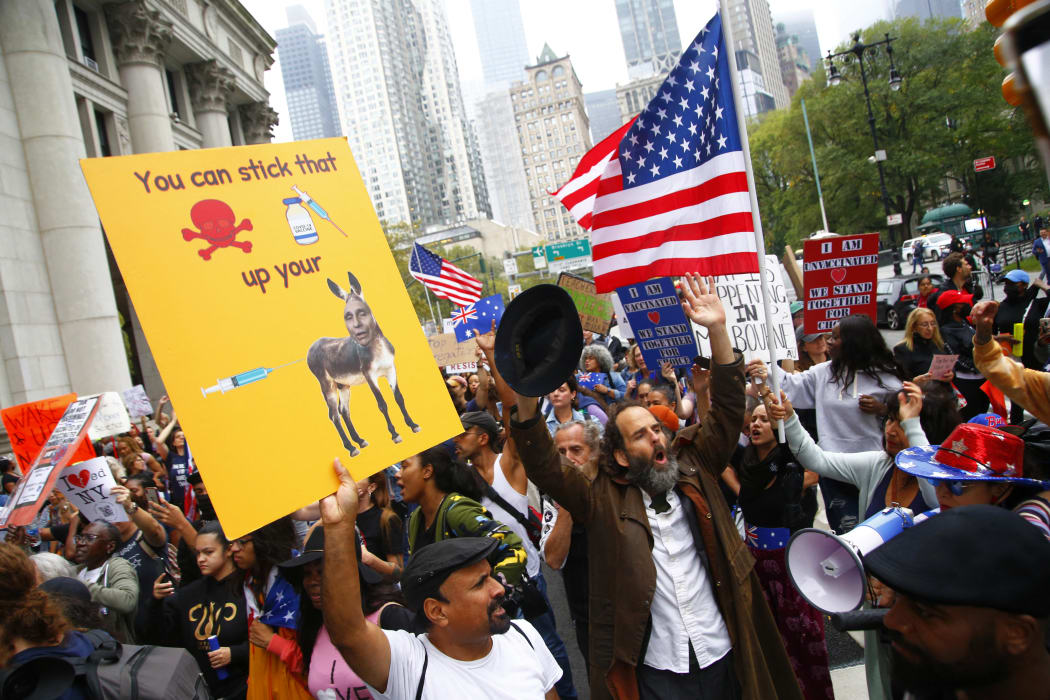 Marchers protest New York's Covid-19  a vaccine mandate for public school employees that came into effect on Monday.