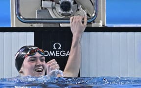 New Zealand's Erika Fairweather reacts after winning the final of the women's 400m freestyle swimming event during the 2024 World Aquatics Championships at Aspire Dome in Doha on February 11, 2024. (Photo by Manan VATSYAYANA / AFP)