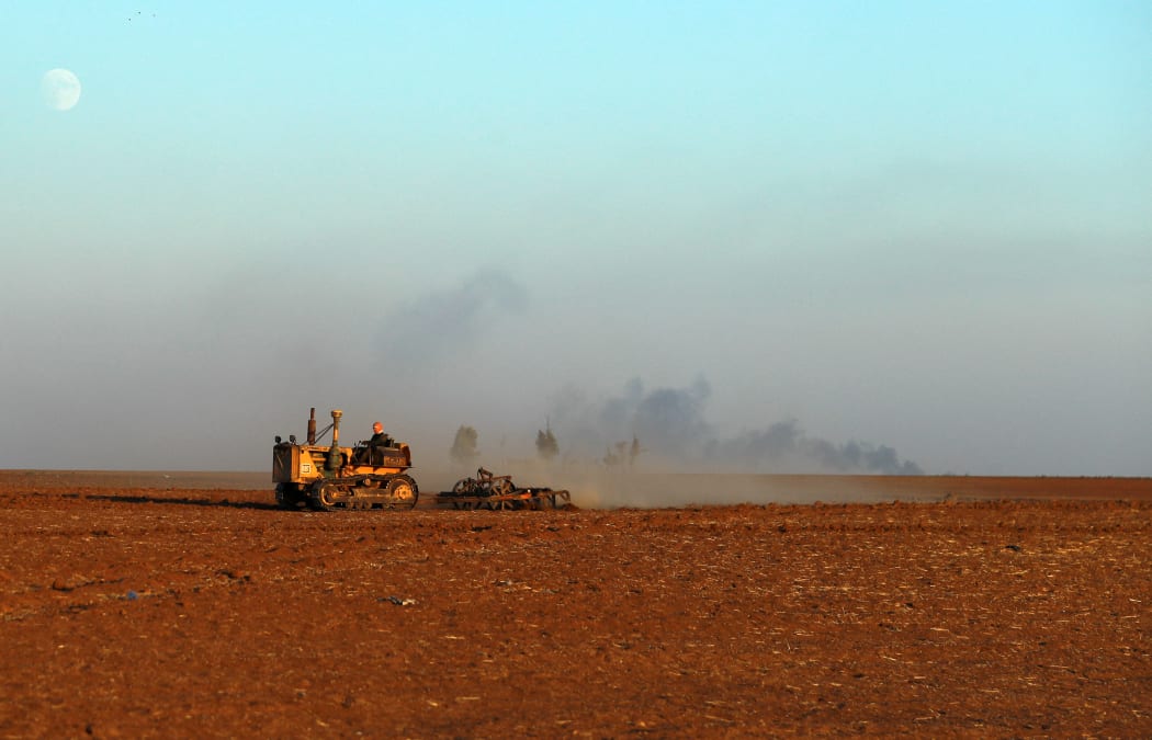 A farmer ploughs a wheat field in the countryside of Syria's breadbasket region. Hasakeh has been hard hit by low rainfall. Farmers in the region have had dismal wheat harvests, raising alarm about food security in a war-torn country where 60 percent of people struggle to buy food.