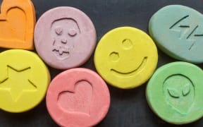 Ecstasy tablets on black background