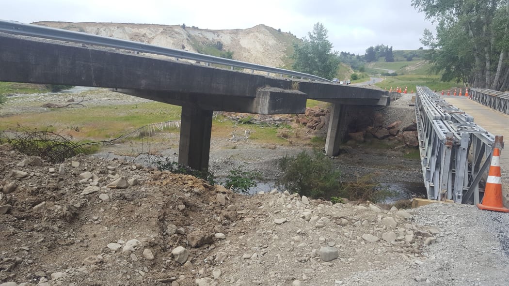 A damaged bridge and temporary replacement bridge on the road between Waiau and Mt Lyford.
