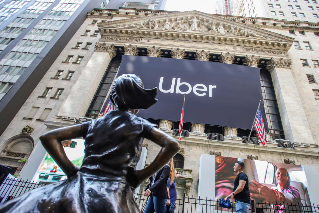 An Uber banner adorns the facade of the New York Stock Exchange ahead of the ride sharing company's IPO.