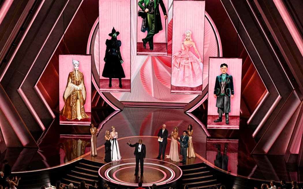 US costume designer Paul Tazewell accepts the award for Best Costume Design for "Wicked" onstage during the 97th Annual Academy Awards at the Dolby Theatre in Hollywood, California on March 2, 2025. (Photo by Patrick T. Fallon / AFP)