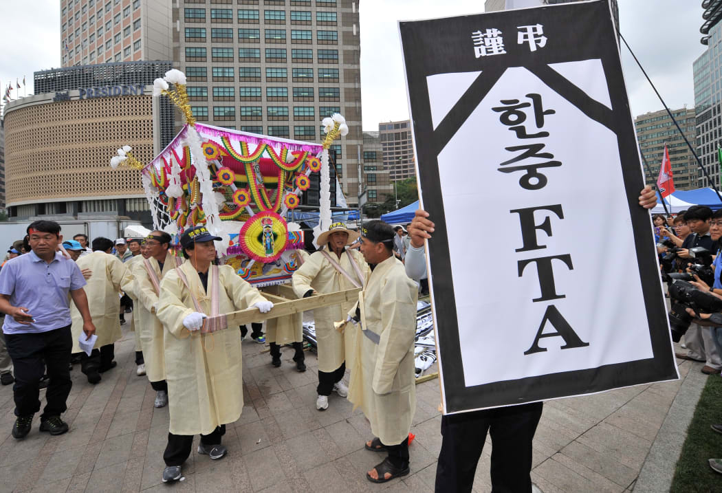 South Korean farmers and fishermen carry a coffin as they protest in Seoul in 2012 against a proposed free trade deal with China. Talks with both New Zealand and China are still going on.
