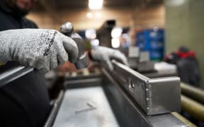 A worker inspects aluminum parts at an auto parts manufacturer in San Luis Potosi, San Luis Potosi state, Mexico, on Monday 17 February 2025.