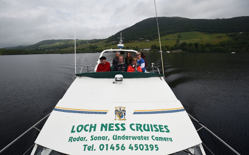 Tourists take a cruise aboard the 'Nessie Hunter' boat on Loch Ness in the Scottish Highlands, Scotland on June 10, 2018.