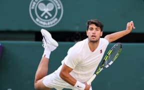 Carlos Alcaraz of Spain serves a ball to Cameron Norrie of United Kingdom during their men's singles quarter-finals match on day nine of the Wimbledon Championships at the All England Lawn Tennis and Croquet Club in London, July 8, 2025. ( The Yomiuri Shimbun ) (Photo by Daisuke Urakami / The Yomiuri Shimbun via AFP)