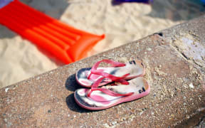 Flip-flops jandals thongs on the beach (Photo by SIMON POTTER / Image Source / Image Source via AFP)