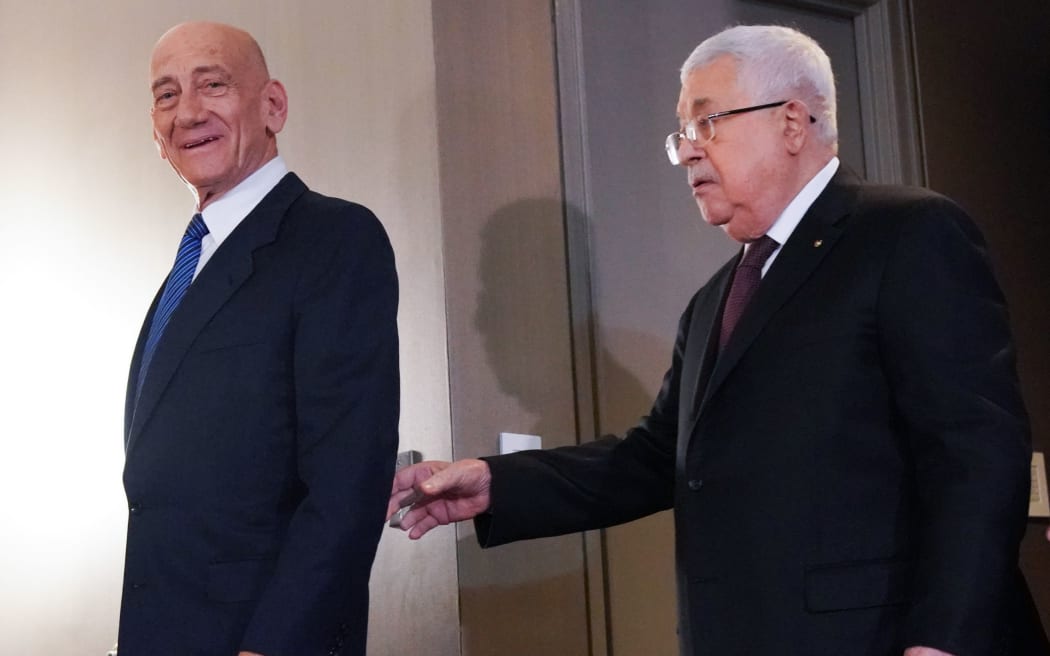 Palestinian president Mahmud Abbas (R) and Former Israeli Prime Minister, Ehud Olmert, arrive for a press conference on US President Donald Trump's Mideast peace plan on February 11, 2020 in New York. -