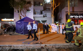 Israeli security forces gather at the site of an attack that left two Israeli police dead in the northern city of Hadera on 27 March 2022.