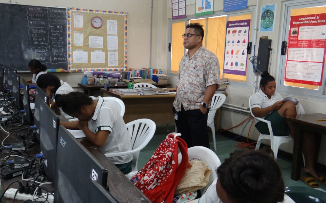 High school students in the Marshall Islands take the recent College of the Marshall Islands placement test under the watchful eye of proctor CMI official Terry Hazzard.