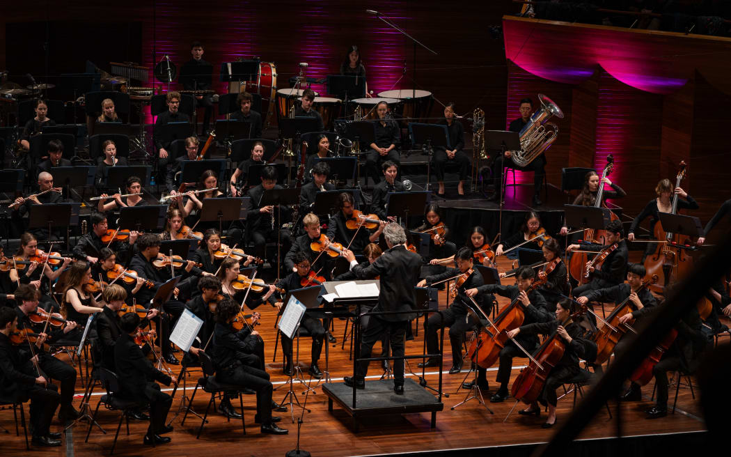 NZSO National Youth Orchestra with conductor Adam Johnson onstage at Wellington's Michael Fowler Centre.