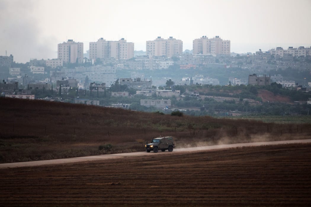 A picture taken from the Israeli border with the Gaza Strip shows an Israeli army vehicle on patrol.