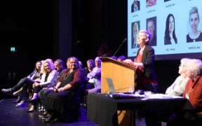 Brie Burgess (at the microphone), who is standing for the Ashburton District Council in the October 2022 local body elections, speaks at a 'meet the candidates' event at Ashburton Event Centre.