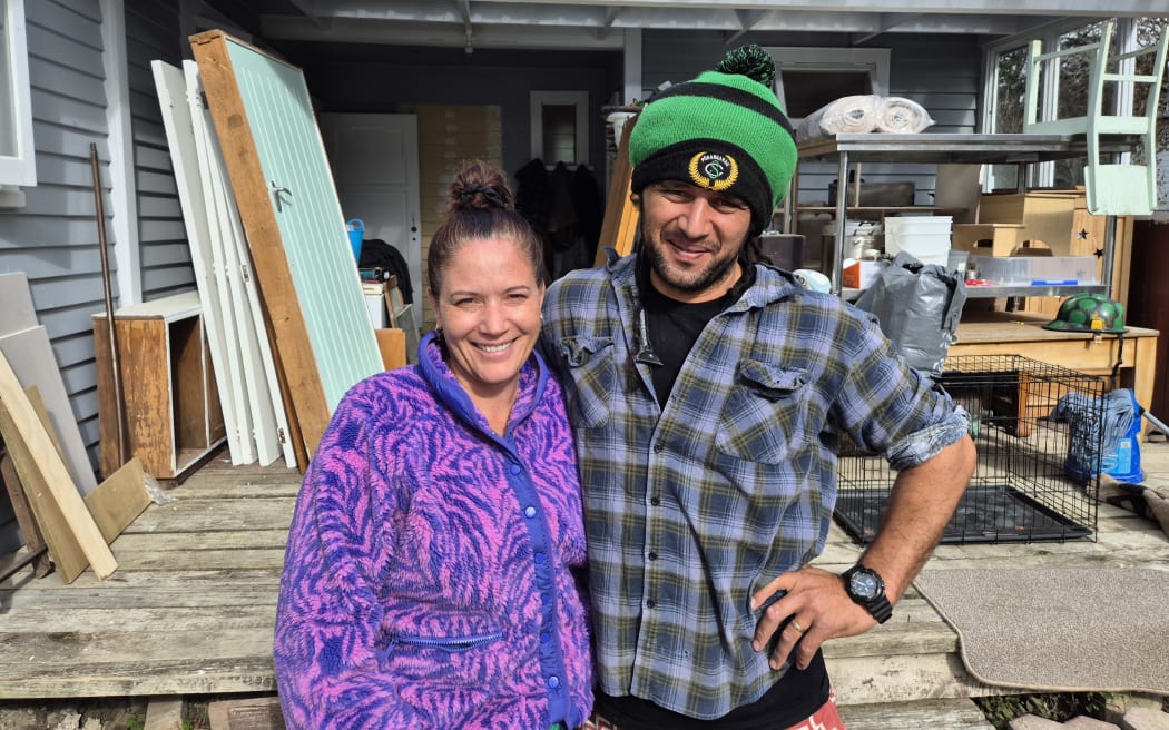 Tania Nicholas and Orlando MacDonald outside their cyclone damaged home