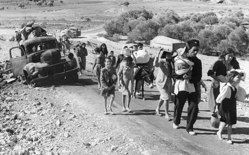 FILE - Palestinian villagers who fled from their homes during fighting between Israeli and Arab troops, on Nov. 4, 1948. (AP Photo/Jim Pringle, File)