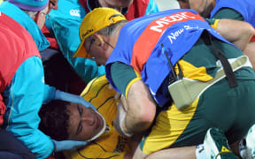 Wallabies player Anthony Faingaa is rolled onto a stretcher after receiving an accidental knee to the head during the 2011 Rugby World Cup.