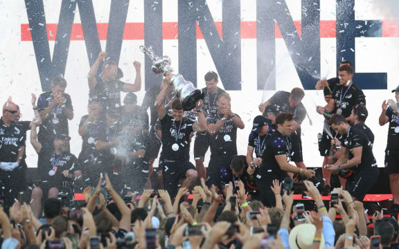 Team New Zealand's skipper Peter Burling (C) holds the America's Cup, affectionately known as the Auld Mug, after winning the 36th America's Cup against Luna Rossa Prada in Auckland on March 17, 2021.