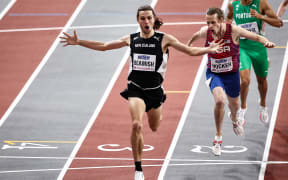 First-placed New Zealand's George Beamish celebrates as he crosses the finish line in the Men's 1500m final during the Indoor World Athletics Championships in Glasgow, 2024.