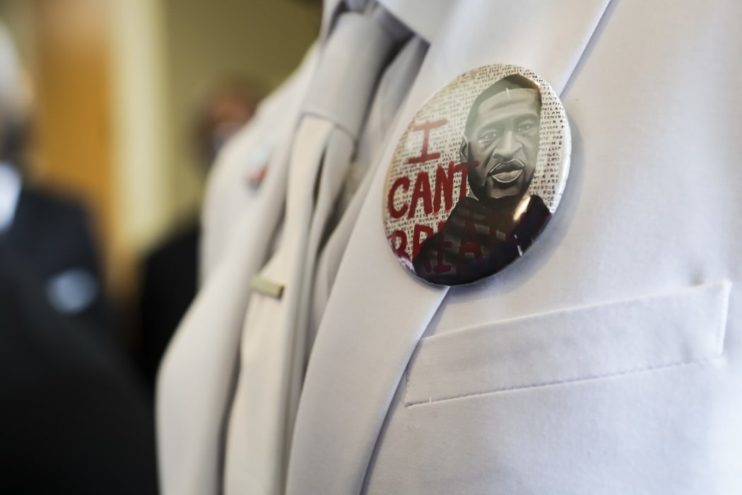 A mourner wears a badge reading "I can't breathe" at the funeral of George Floyd on June 9, 2020, in Houston, Texas.