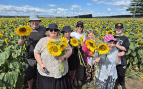 The Paul Hunter Centre love visiting the sunflowers, and Charlotte (centre) teaches them about how the crop grows.