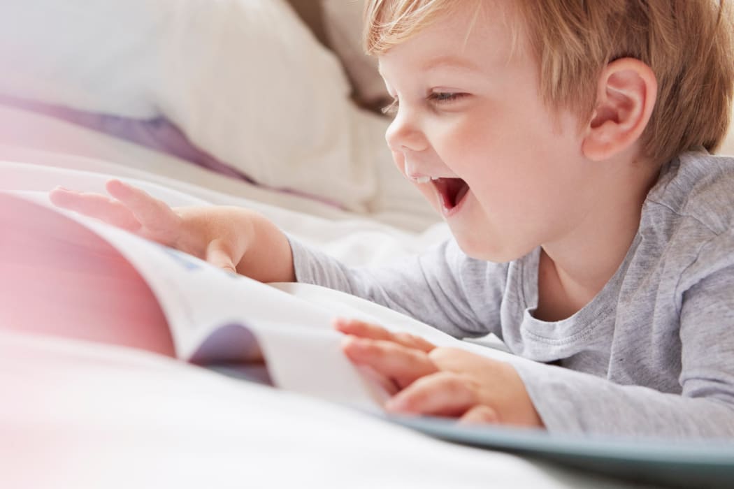 boy reading and smiling