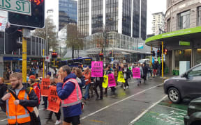 Protesters march to the Austrian oil giant OMV's Majestic Centre headquarters in Wellington.