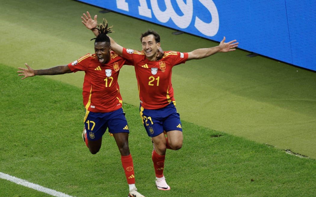 Spain's midfielder #21 Mikel Oyarzabal celebrates with Spain's midfielder #17 Nico Williams after scoring his team's second goal during the UEFA Euro 2024 final football match between Spain and England at the Olympiastadion in Berlin on July 14, 2024. (Photo by Odd ANDERSEN / AFP)