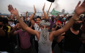 Iraqi protesters chant slogans during a demonstration against state corruption, failing public services and unemployment at Tayaran square in Baghdad.