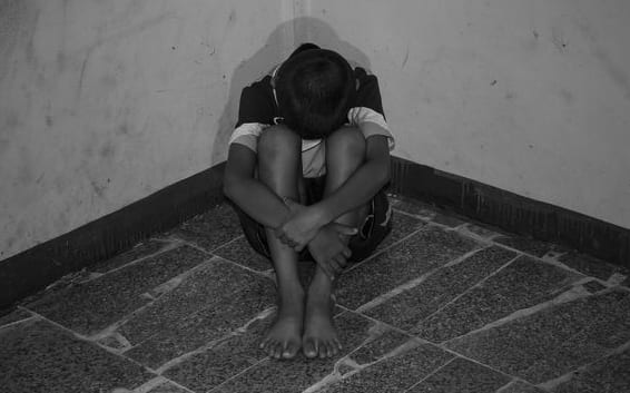 Child with head in hands