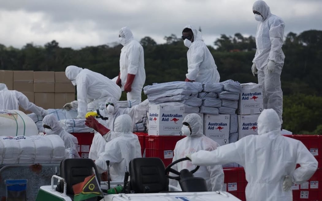 Australian air force personnel unload cyclone aid in Port Vila.
